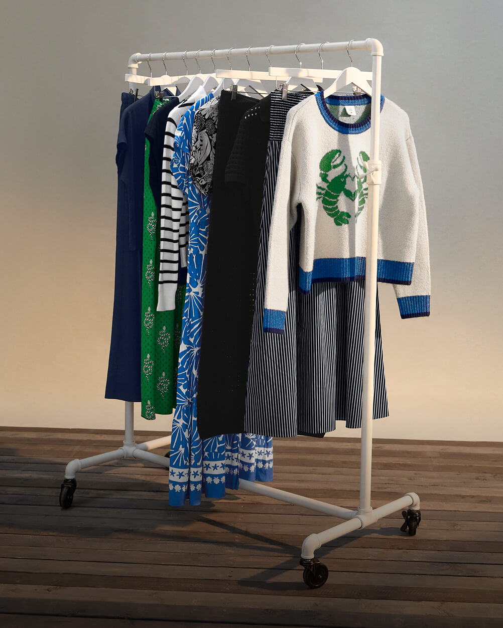 Clothing rack with various New Arrivals clothes on it